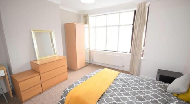 Bright and inviting double bedroom featuring la...