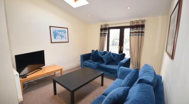 Spacious and inviting living room featuring com...