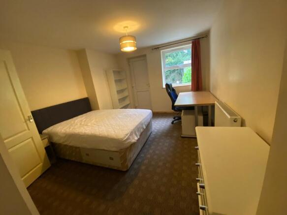 Spacious double bedroom featuring a comfortable...