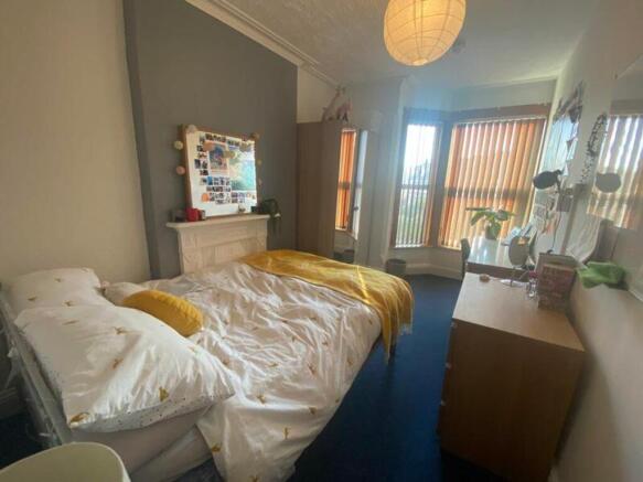 A bright and inviting double bedroom with large...