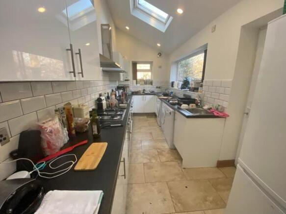 A spacious and well-lit kitchen with modern app...