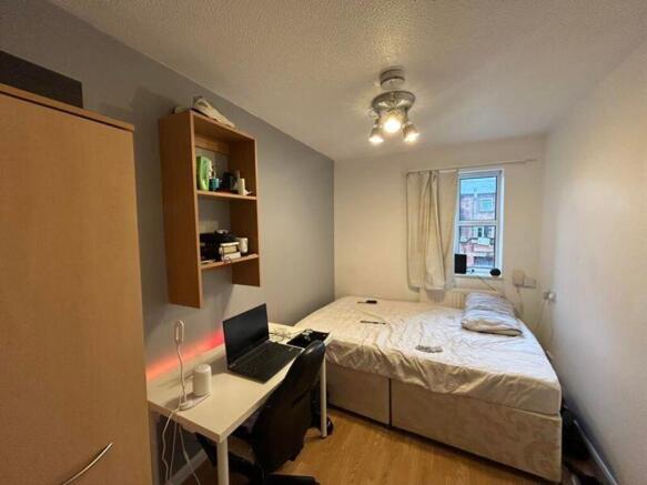 A cozy double bedroom featuring a comfortable b...