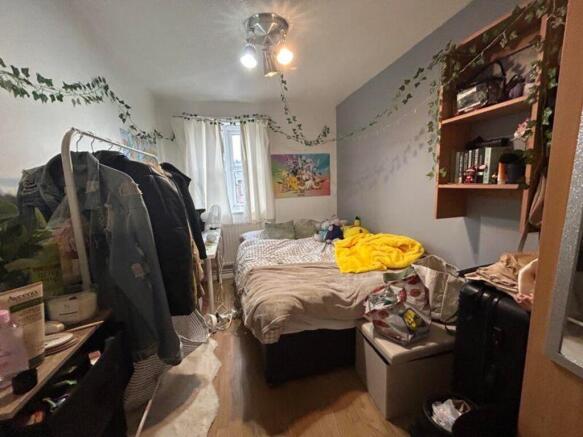 A cozy double bedroom with good natural light a...
