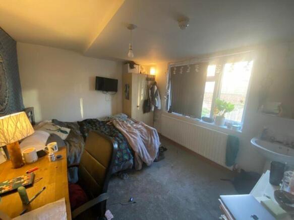 A cozy double bedroom with ample natural light,...