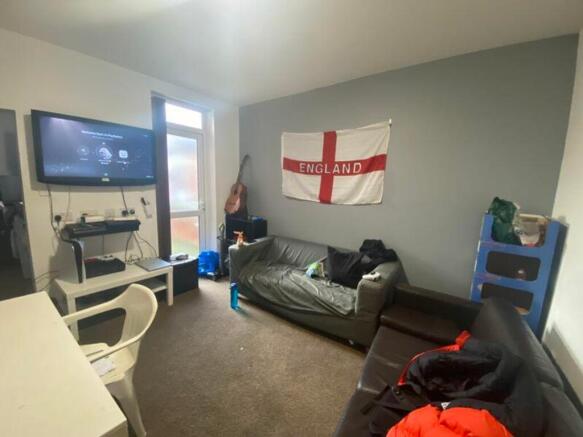 A spacious living room with good natural light ...