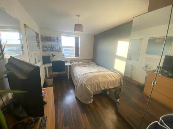 A bright and inviting double bedroom featuring ...