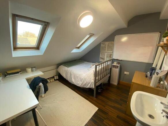 A bright and inviting double bedroom featuring ...