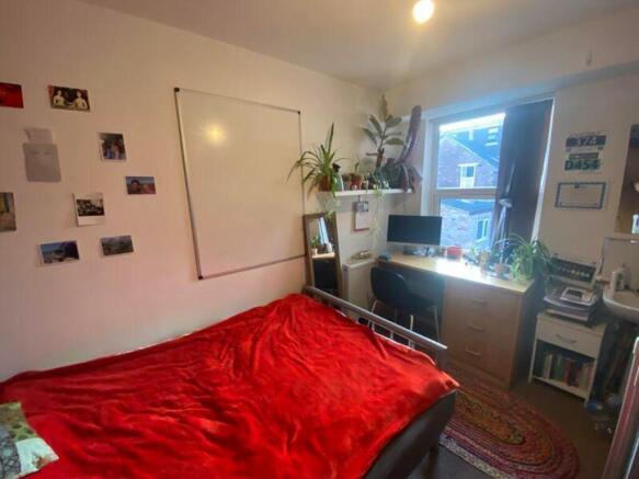 A cozy and well-lit double bedroom featuring a ...