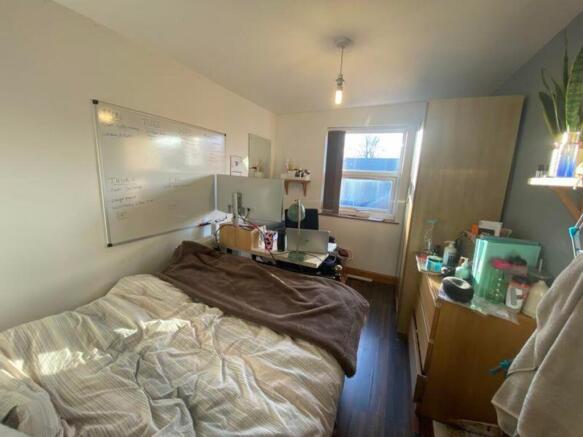 A cozy double bedroom featuring ample natural l...