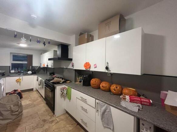 A spacious and well-lit kitchen with ample stor...