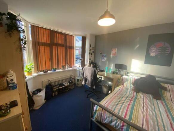 A bright and inviting double bedroom with plent...