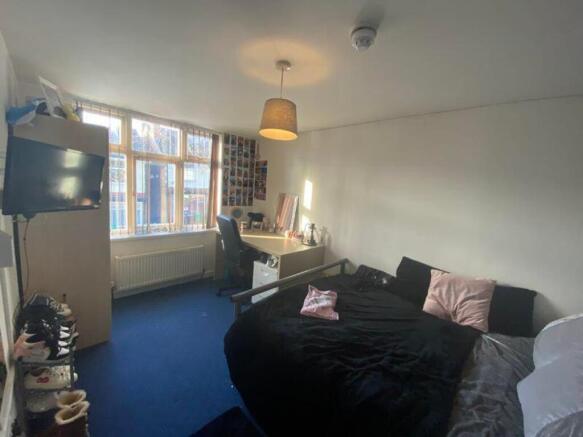 A spacious and inviting double bedroom filled w...