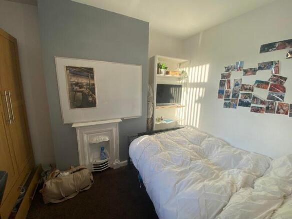 A cozy and inviting double bedroom with ample n...