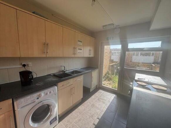 Spacious kitchen featuring modern cabinetry, am...