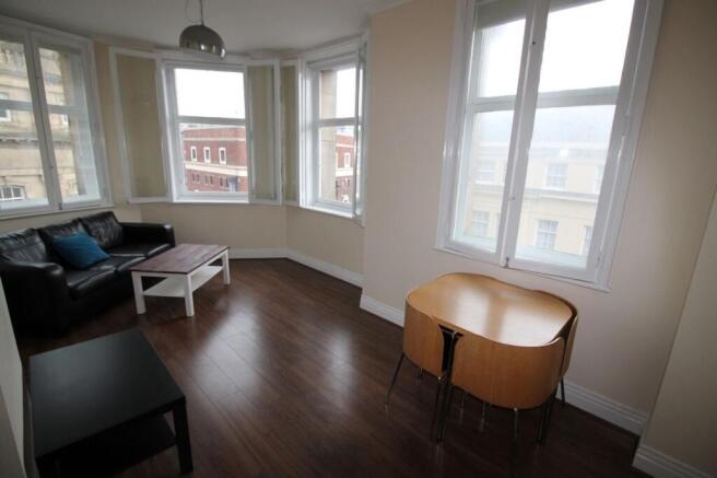 Bright and inviting living room featuring large...