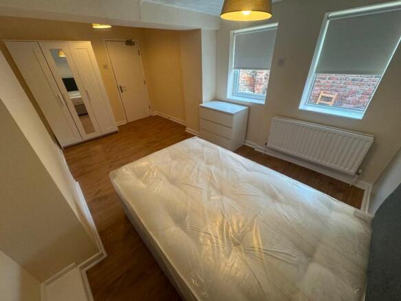 Spacious double bedroom featuring natural light...