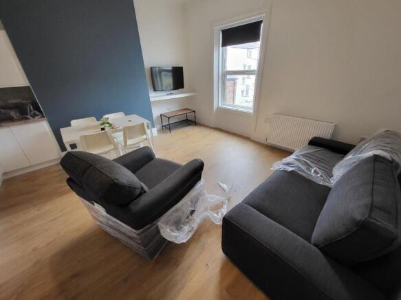 A bright and modern living room featuring styli...