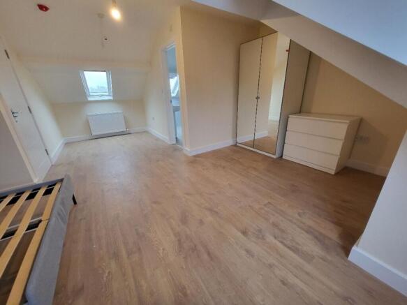 Spacious double bedroom featuring ample natural...