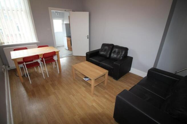 Spacious living room featuring comfortable seat...
