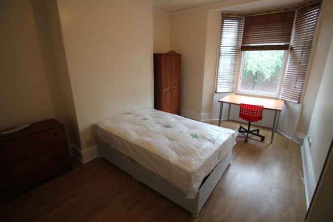 Bright and inviting double bedroom featuring la...