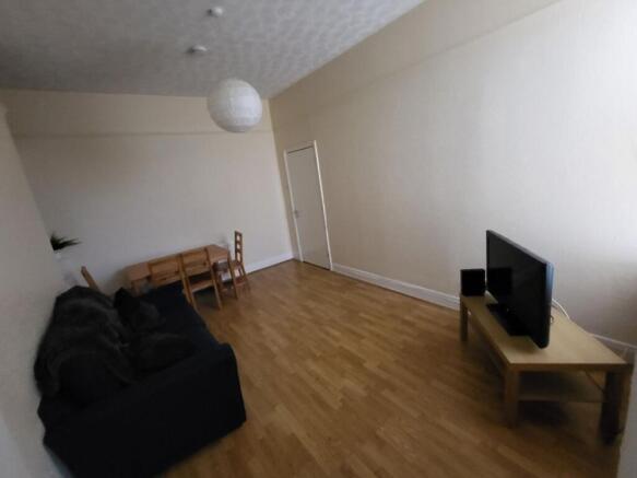 Spacious living room featuring a cozy sofa and ...