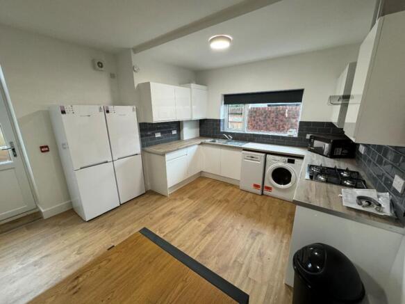 Modern kitchen featuring ample storage space wi...