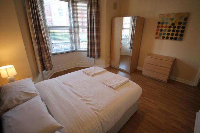 This inviting double bedroom features ample nat...