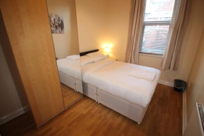 A cozy double bedroom featuring a comfortable b...