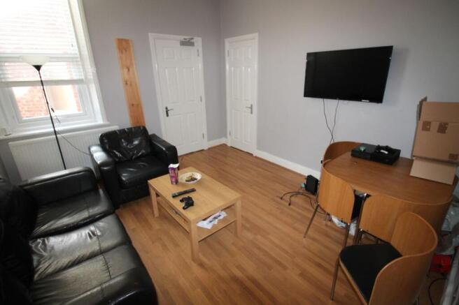 Bright and spacious living room featuring comfo...