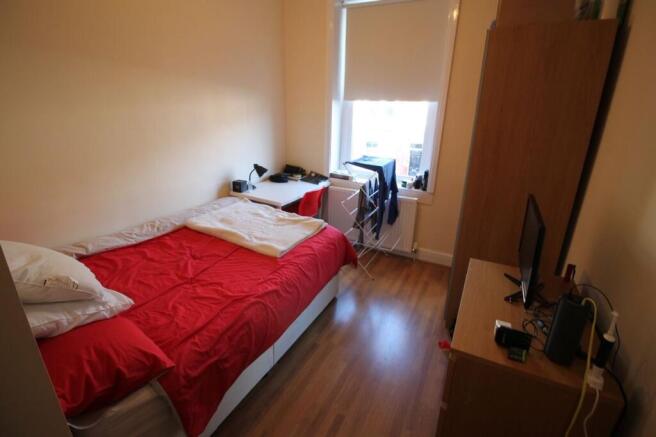 Cozy double bedroom featuring a comfortable bed...