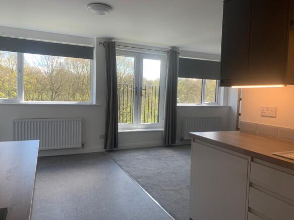 Bright and spacious living room featuring large...