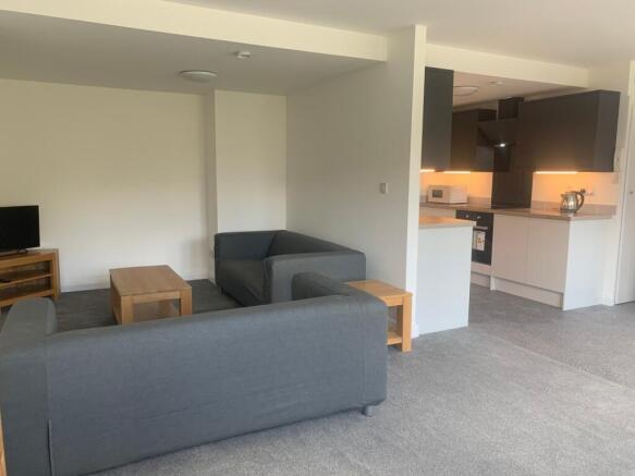 Spacious and modern living room featuring comfo...