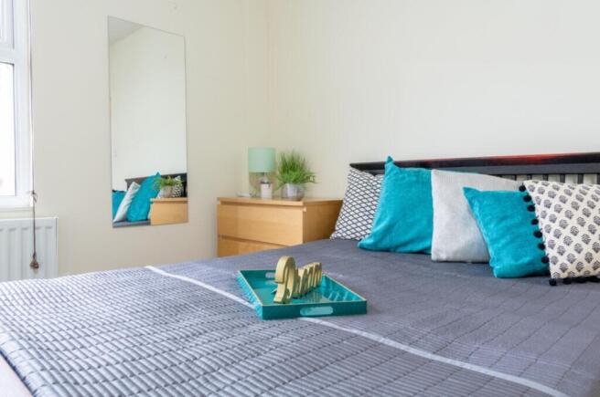 This inviting double bedroom features a contemp...