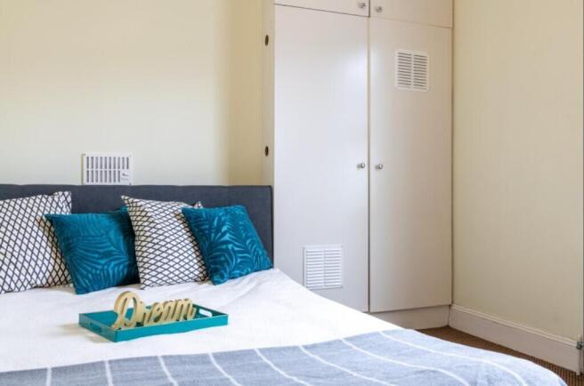 This inviting double bedroom features a cozy la...