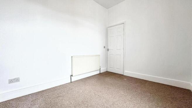 A bright and inviting single bedroom featuring ...