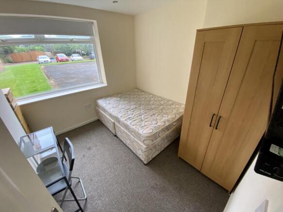 A bright and tidy double bedroom with a comfort...