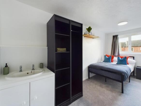 A bright and tidy double bedroom featuring a st...