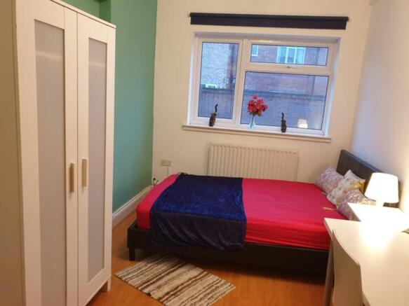 This inviting double bedroom features a cozy la...