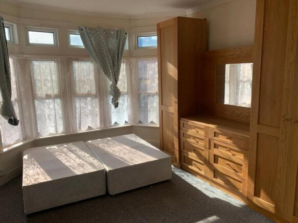 Bright and spacious double bedroom featuring la...
