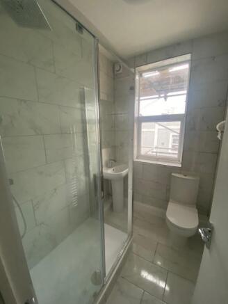This stylish bathroom features a modern shower ...