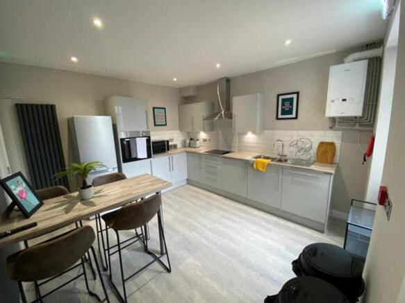 Modern and spacious kitchen equipped with sleek...