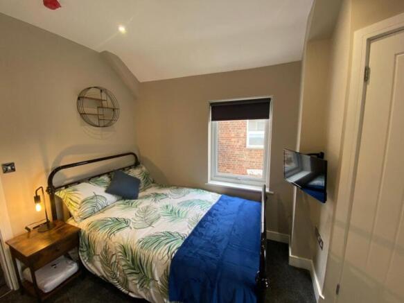 A stylish double bedroom featuring a comfortabl...