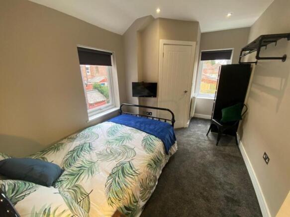 A stylish double bedroom featuring a comfortabl...