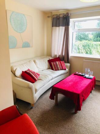 A cozy living room featuring a comfortable whit...