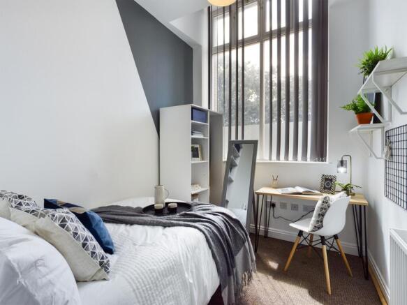 A bright and inviting double bedroom featuring ...