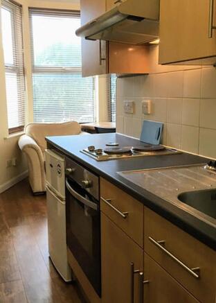 Bright and modern kitchen equipped with essenti...