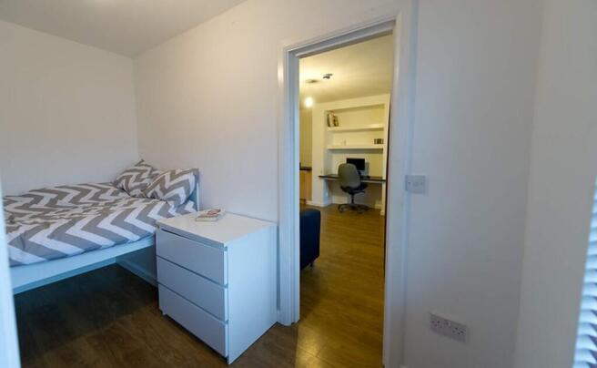 This inviting double bedroom features a cozy be...
