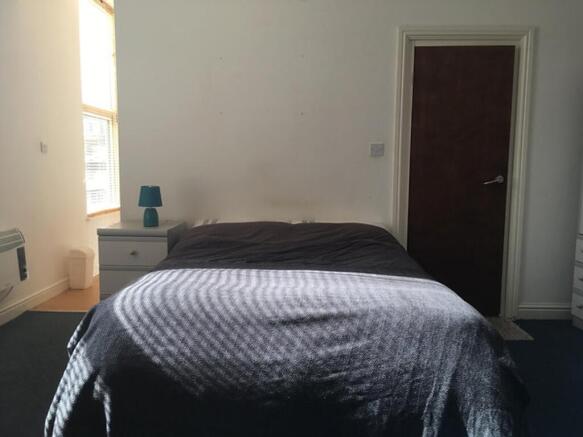 A cozy double bedroom with ample natural light ...