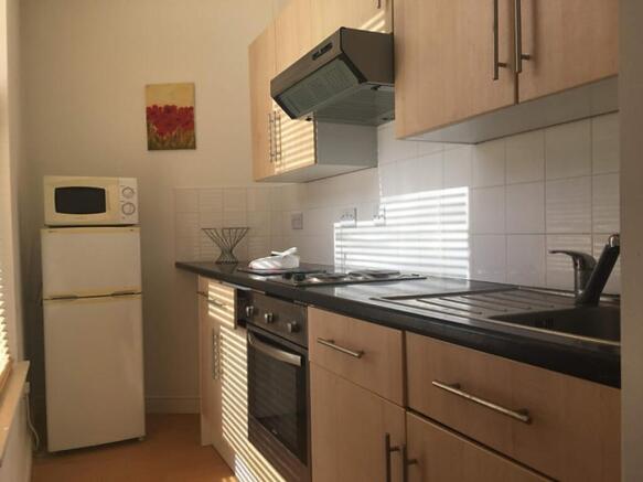 Bright and modern kitchen featuring sleek cabin...