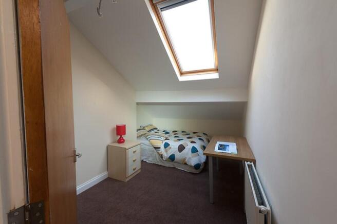 This charming double bedroom features a cozy la...